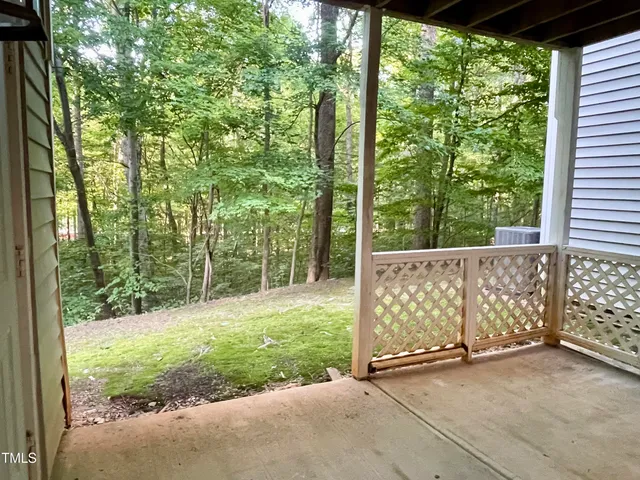 a view of a room with wooden floor and a ceiling fan