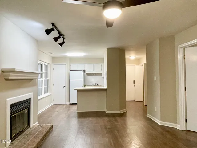 a view of kitchen with livingroom and wooden floor