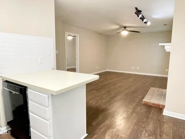 a view of a kitchen with wooden floor