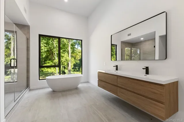 a bathroom with a large tub sink and window
