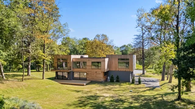 a view of a house with swimming pool and a yard