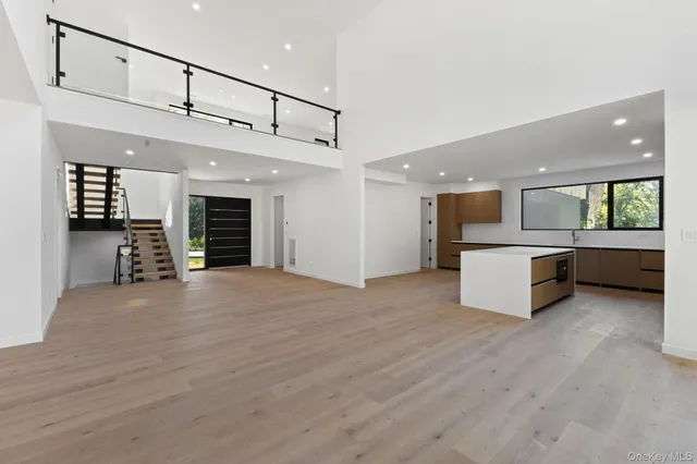 a view of a kitchen with a sink and an empty room