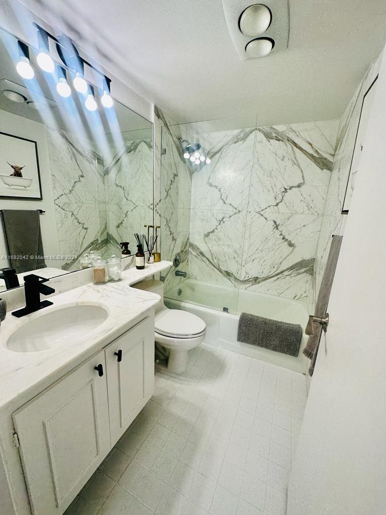 199 Ocean Ln Drive, Unit 613 Key Biscayne, FL 33149 - Photo 8 of 11 a bathroom with a sink and mirror with toilet