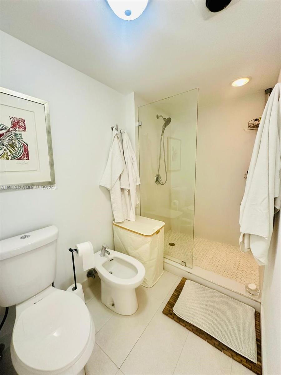 199 Ocean Ln Drive, Unit 613 Key Biscayne, FL 33149 - Photo 10 of 11 a white toilet sitting next to a bath tub shower