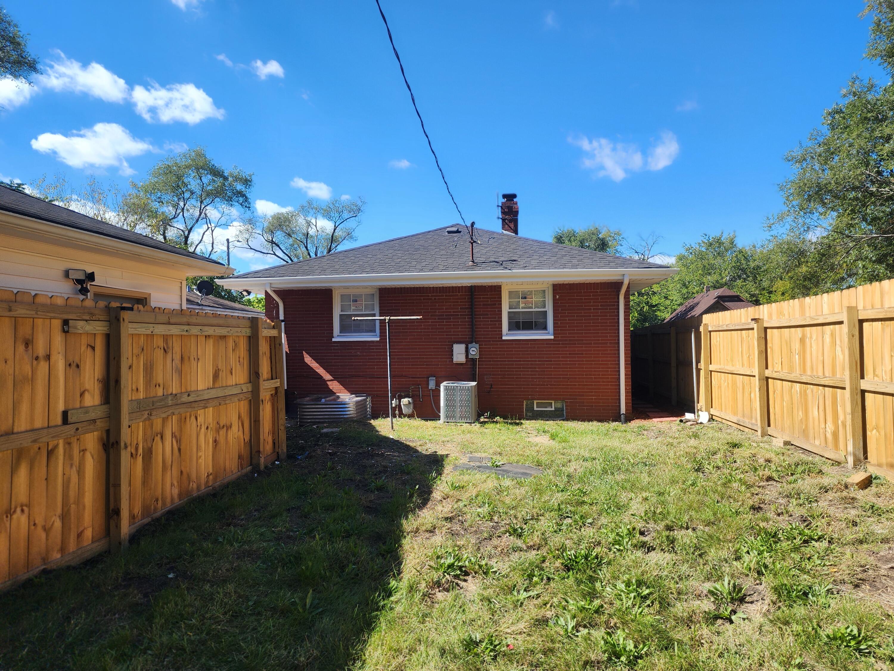 851 Johnson Street Gary, IN 46402 - Photo 20 of 24 a front view of a house with a yard