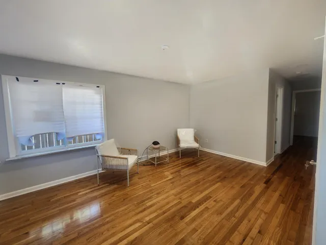 a view of a room with wooden floor and chair