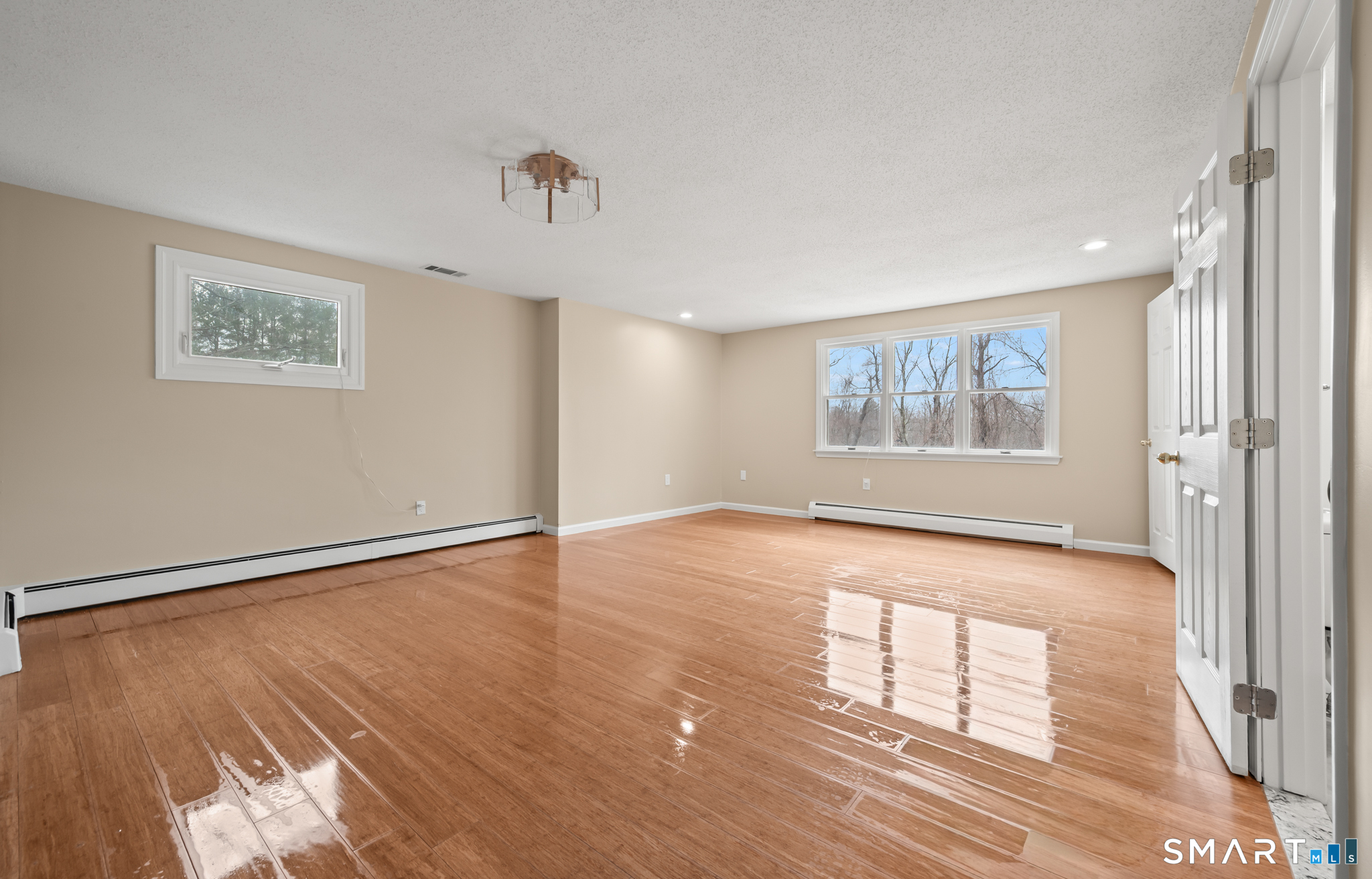 252 Blue Ridge Drive Manchester, CT 06040 - Photo 20 of 40 Spacious primary bedroom with hardwood flooring and natural light.