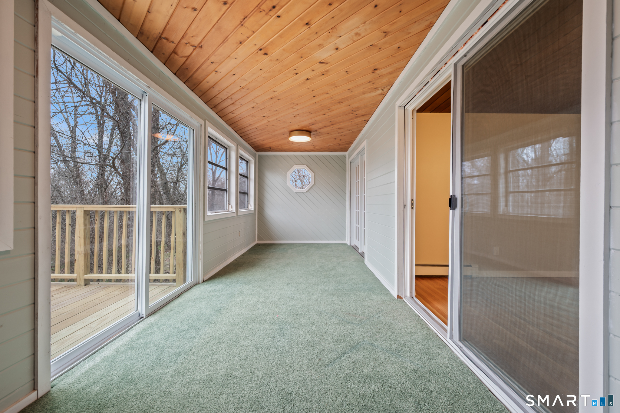252 Blue Ridge Drive Manchester, CT 06040 - Photo 7 of 40 Three-season sunroom offering additional living space and backyard views.