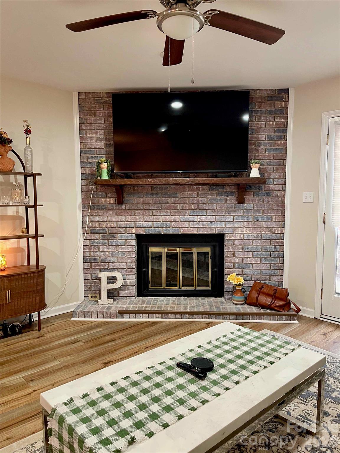 1330 5th Street Northeast, Unit 191 Hickory, NC 28601 - Photo 15 of 37 a living room with fireplace furniture and a flat screen tv