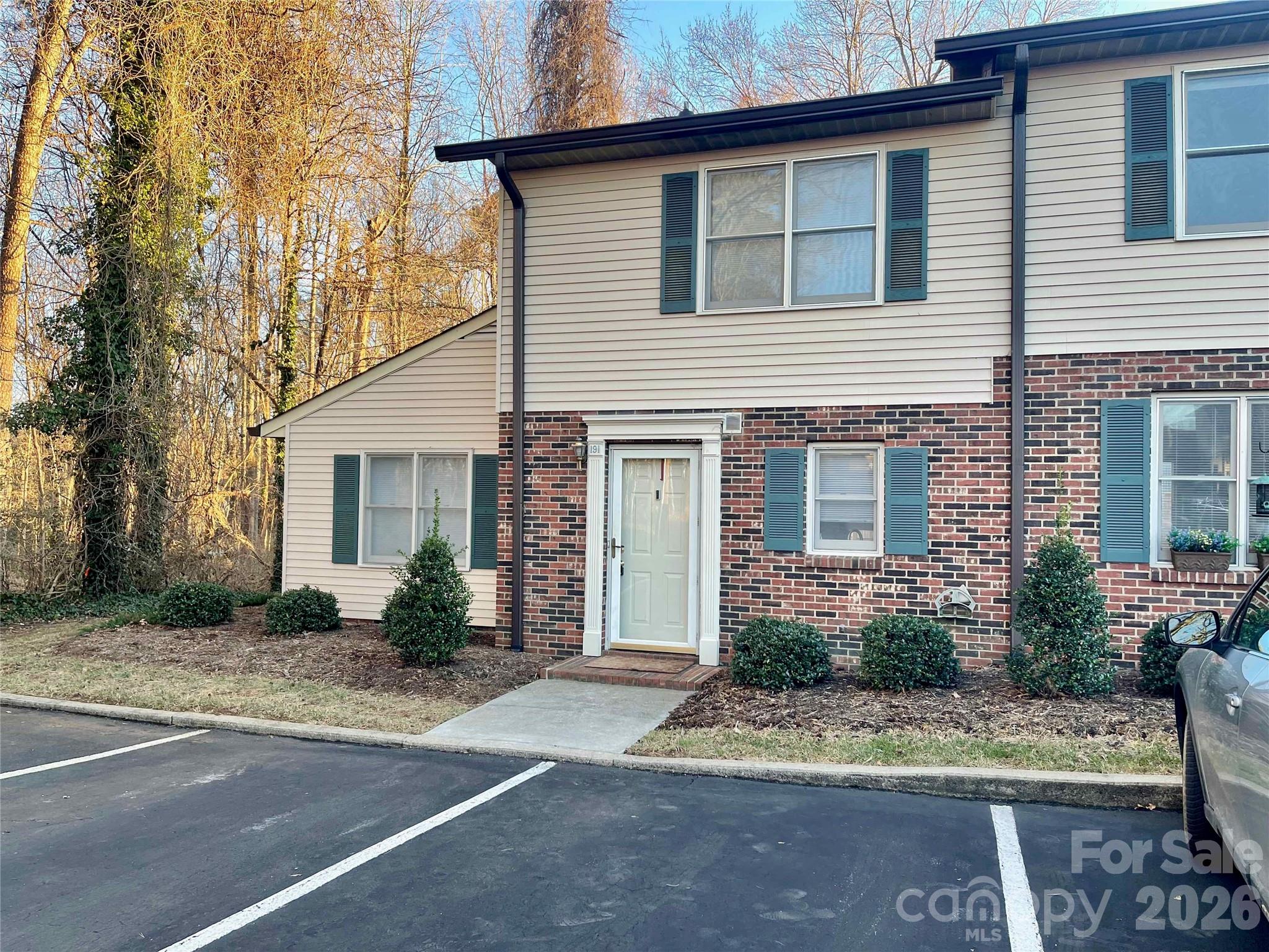 1330 5th Street Northeast, Unit 191 Hickory, NC 28601 - Photo 2 of 37 a front view of a house with a yard and a garage