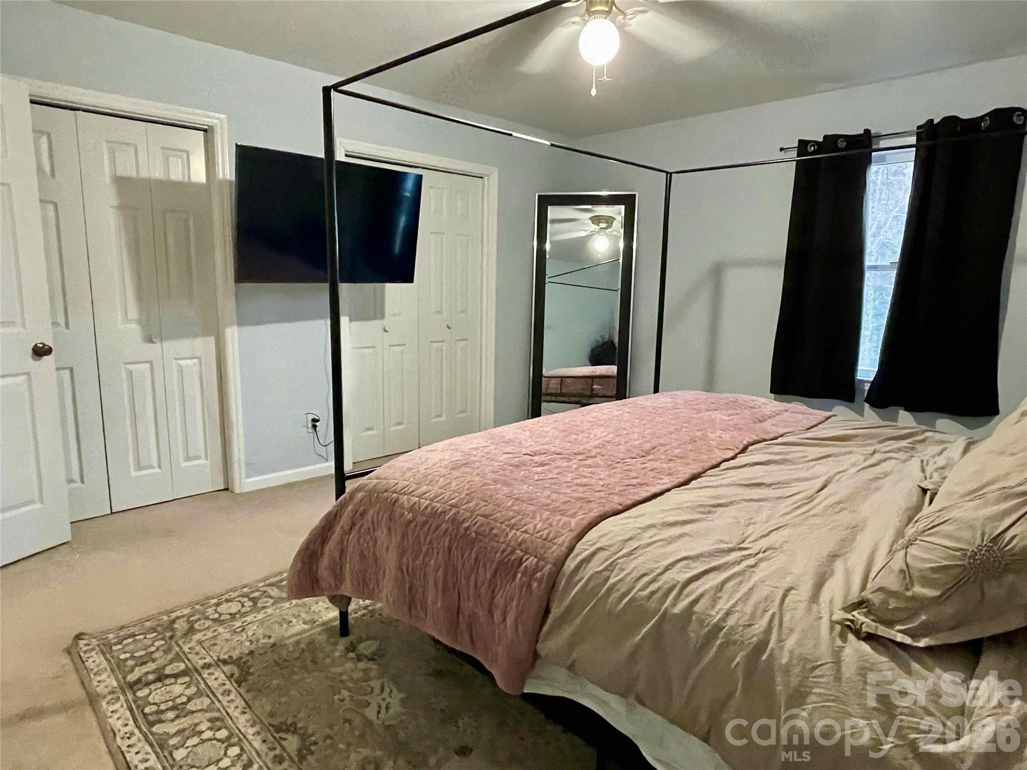 1330 5th Street Northeast, Unit 191 Hickory, NC 28601 - Photo 25 of 37 a bedroom with a bed and a mirror