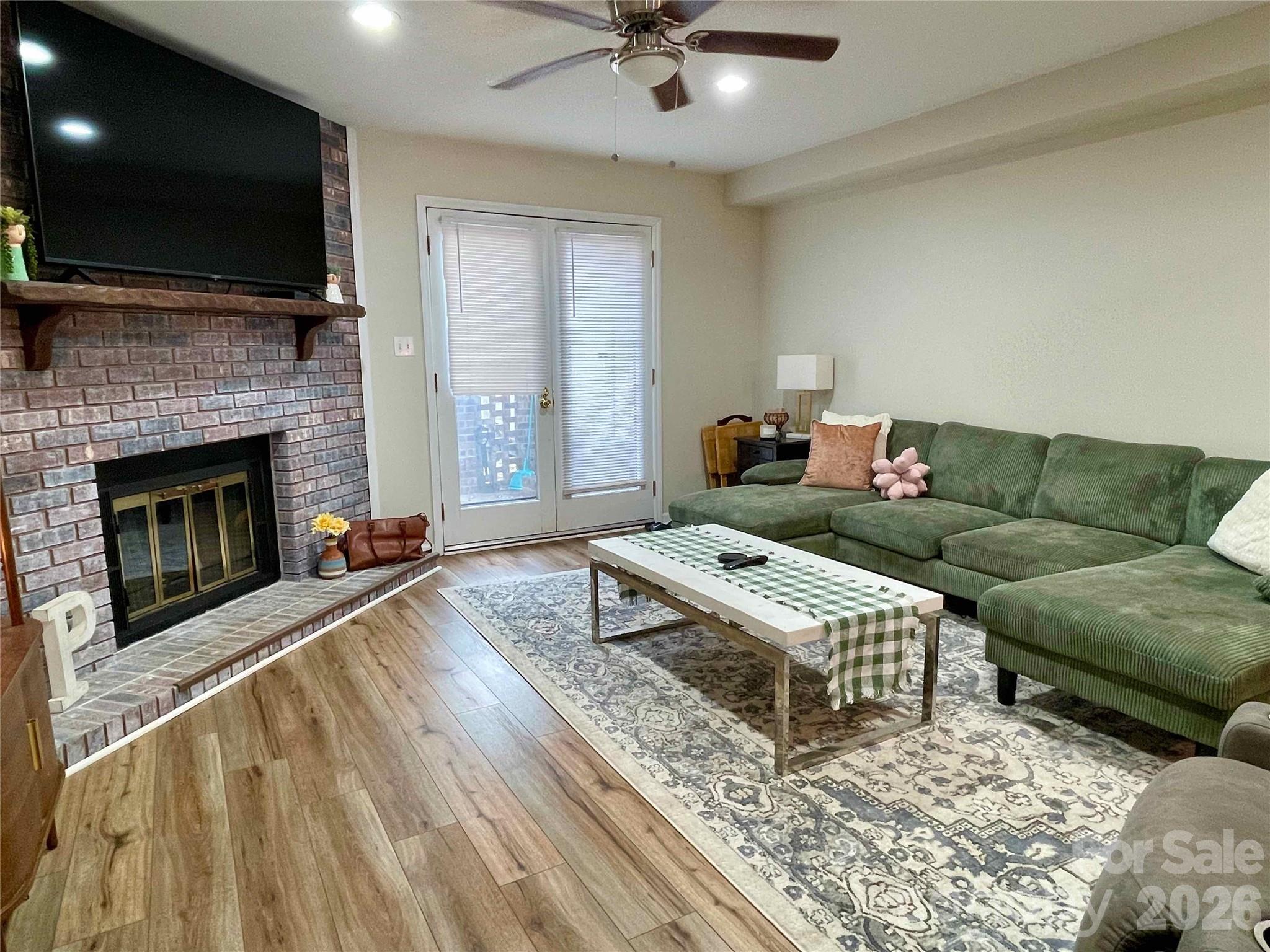 1330 5th Street Northeast, Unit 191 Hickory, NC 28601 - Photo 6 of 37 a living room with furniture a flat screen tv and a fireplace