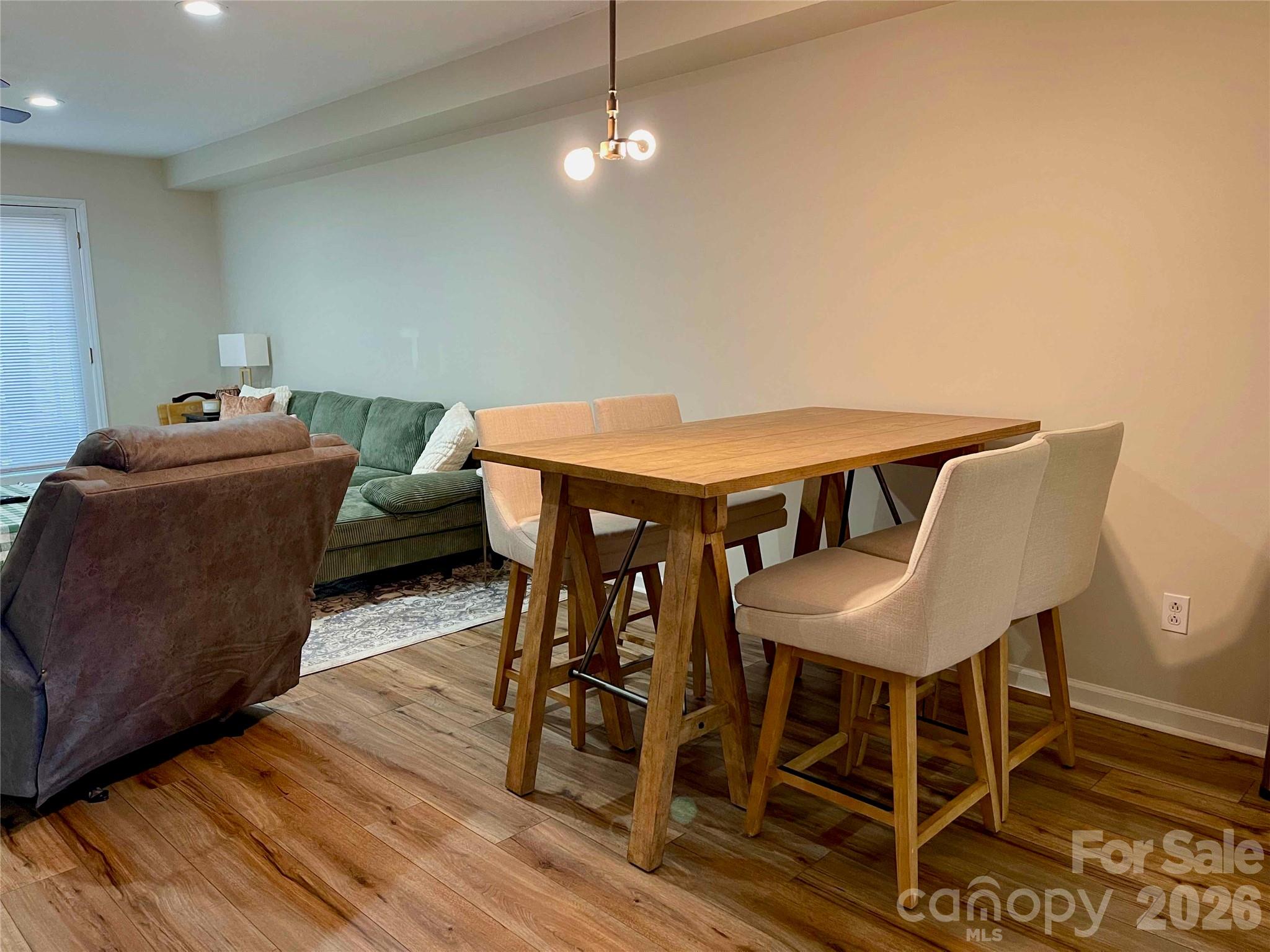 1330 5th Street Northeast, Unit 191 Hickory, NC 28601 - Photo 9 of 37 a view of a dining room with furniture and wooden floor