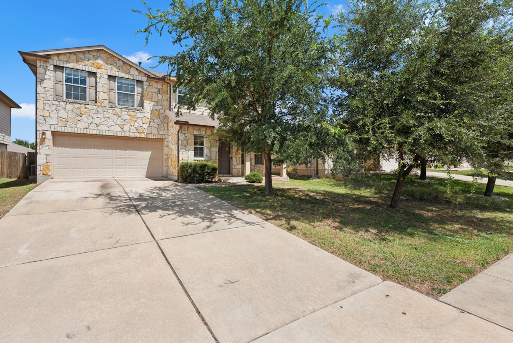 458 Nottingham Loop Kyle, TX 78640 - Photo 35 of 38 a front view of a house with a yard