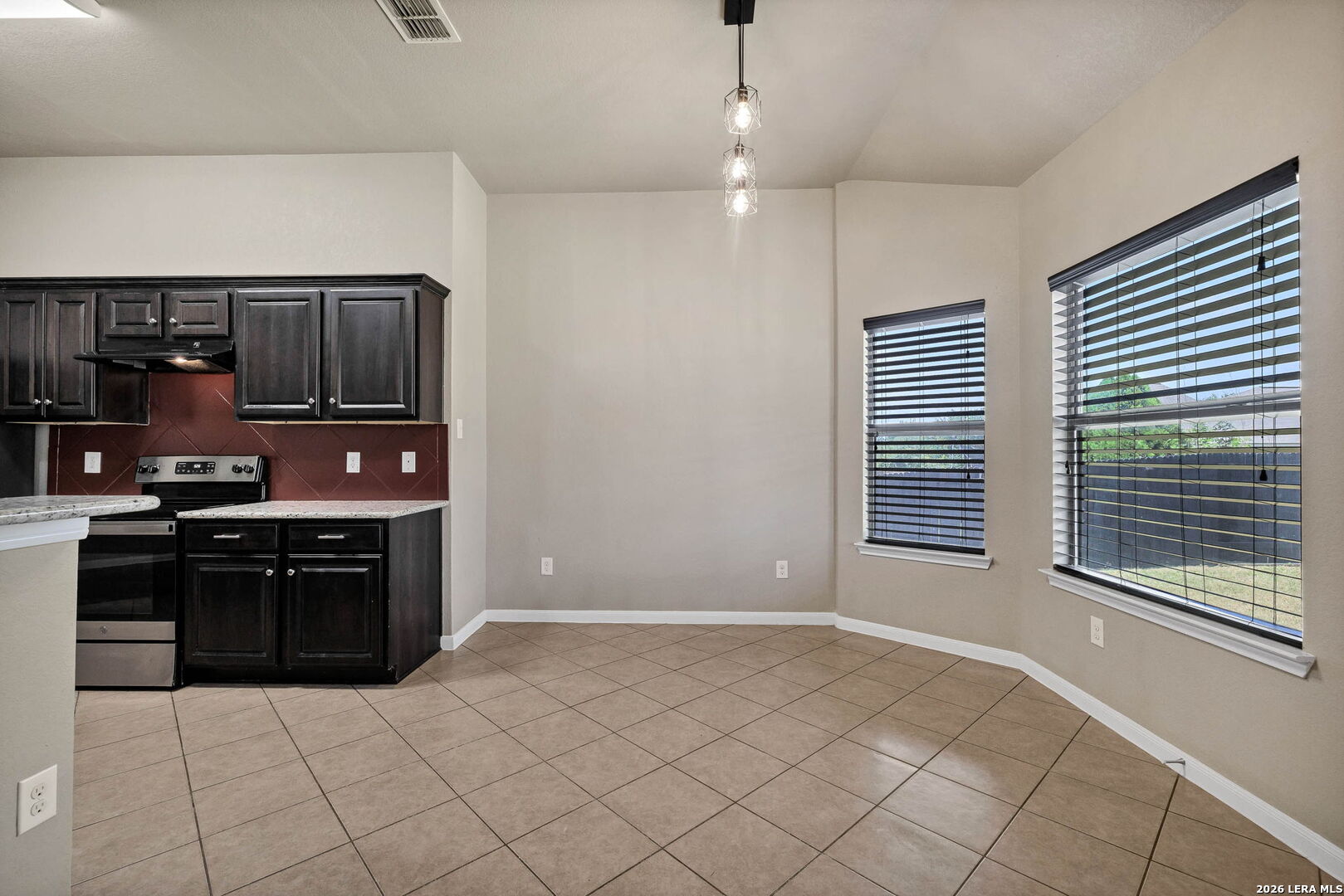 4015 Shervin Way Converse, TX 78109 - Photo 13 of 43 a kitchen with stainless steel appliances granite countertop a stove and cabinets