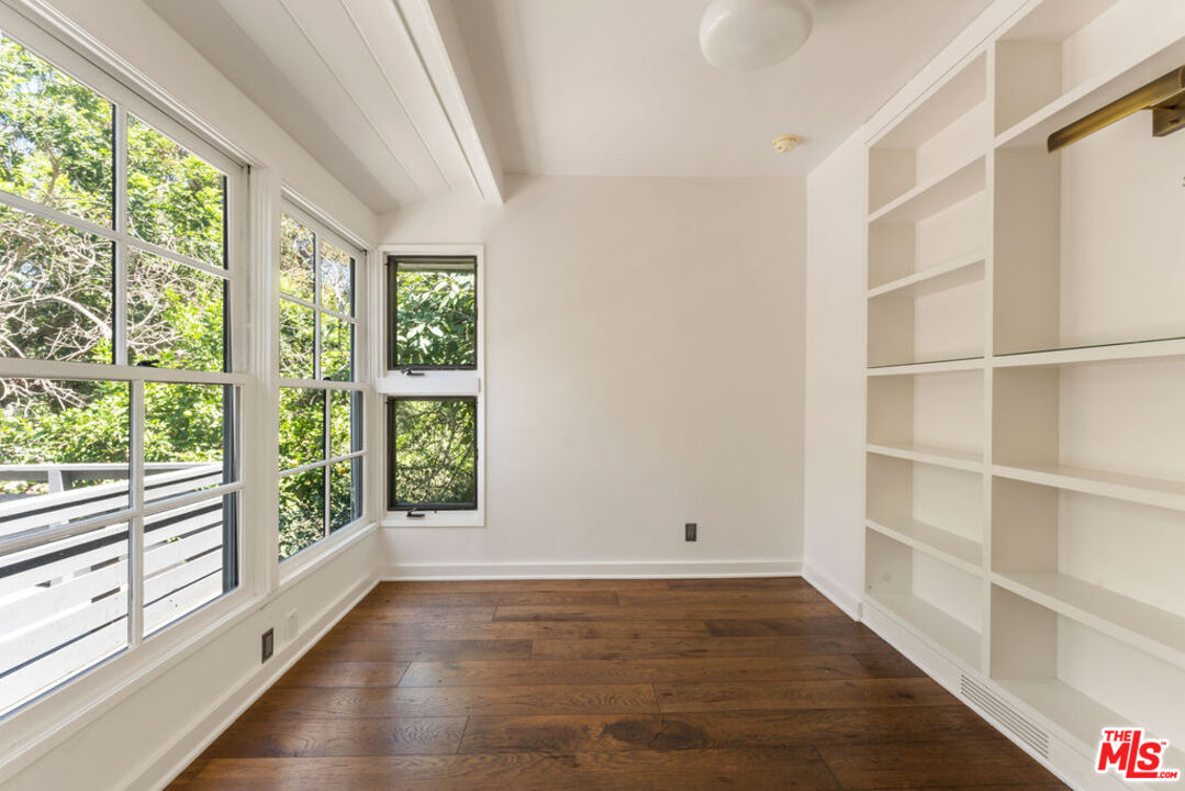1530 Elevado Street Los Angeles, CA 90026 - Photo 15 of 44 a view of an empty room with wooden floor and a window