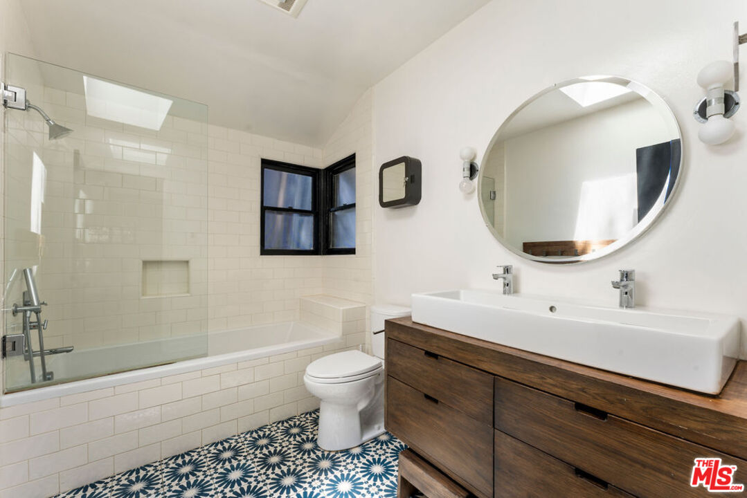 1530 Elevado Street Los Angeles, CA 90026 - Photo 17 of 44 a bathroom with a toilet sink and mirror