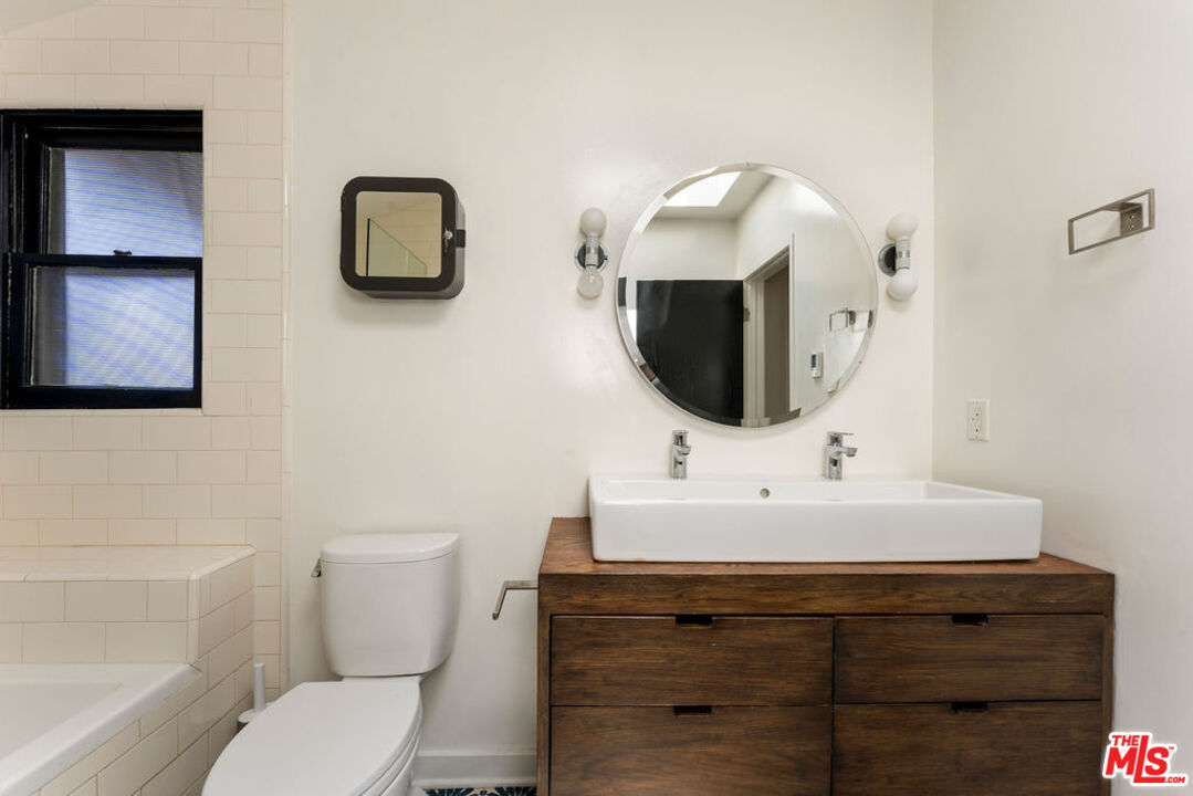 1530 Elevado Street Los Angeles, CA 90026 - Photo 18 of 44 a bathroom with a toilet sink and mirror