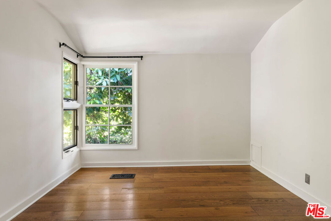 1530 Elevado Street Los Angeles, CA 90026 - Photo 20 of 44 an empty room with wooden floor and windows