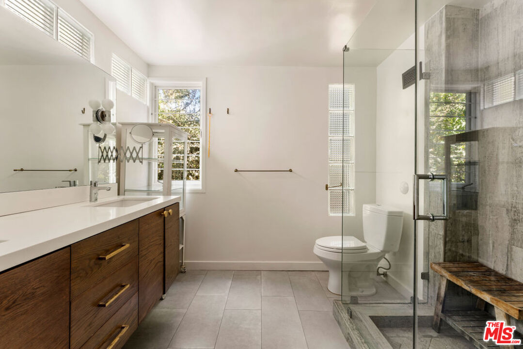 1530 Elevado Street Los Angeles, CA 90026 - Photo 22 of 44 a bathroom with a sink a toilet a mirror and shower