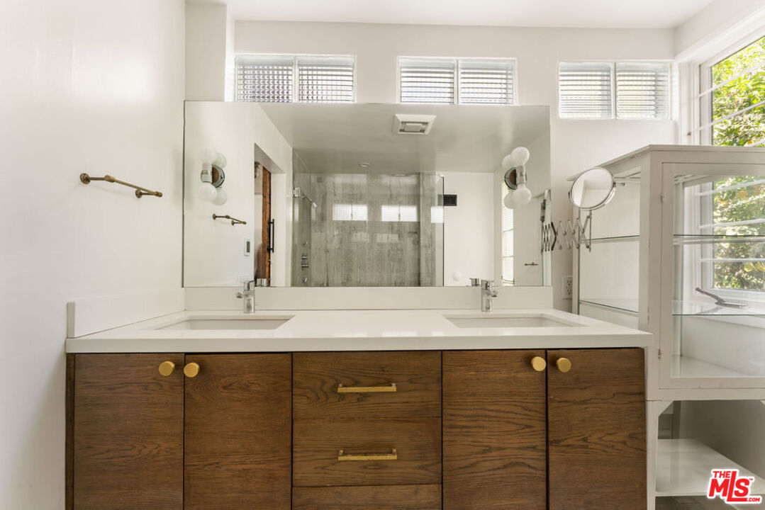 1530 Elevado Street Los Angeles, CA 90026 - Photo 23 of 44 a bathroom with a granite countertop sink and a mirror