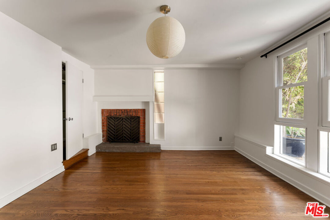 1530 Elevado Street Los Angeles, CA 90026 - Photo 26 of 44 a view of an empty room with wooden floor and a window