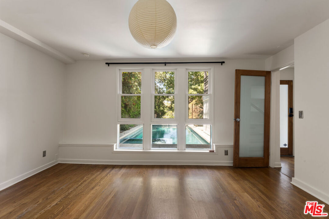 1530 Elevado Street Los Angeles, CA 90026 - Photo 29 of 44 an empty room with wooden floor and windows