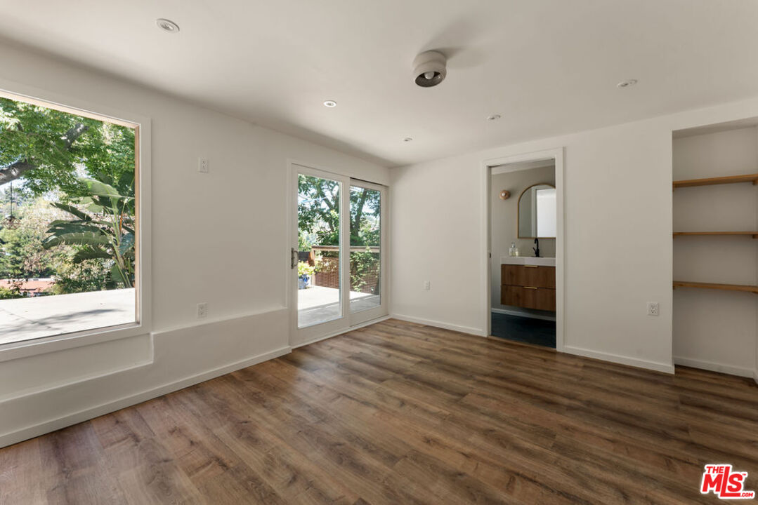 1530 Elevado Street Los Angeles, CA 90026 - Photo 30 of 44 a view of an empty room with a window and wooden floor