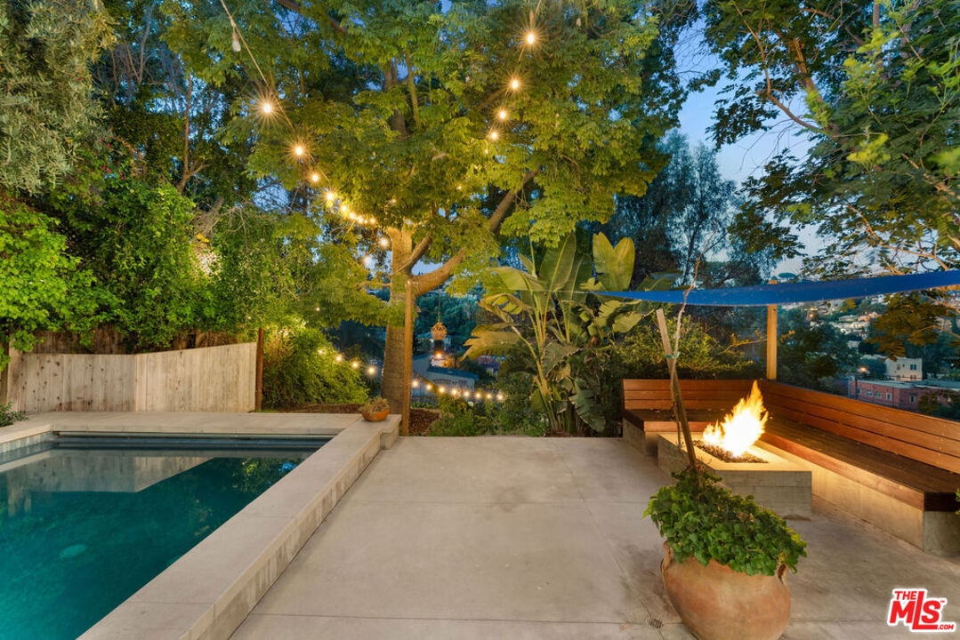 1530 Elevado Street Los Angeles, CA 90026 - Photo 3 of 44 a backyard of a house with table and chairs