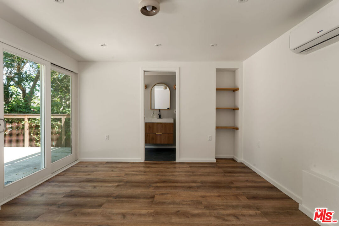 1530 Elevado Street Los Angeles, CA 90026 - Photo 31 of 44 a view of empty room with wooden floor and fan