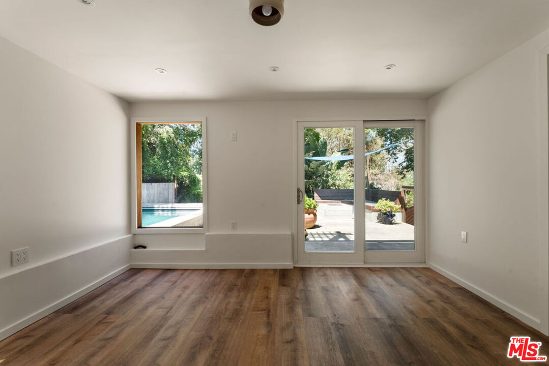 1530 Elevado Street Los Angeles, CA 90026 - Photo 32 of 44 an empty room with wooden floor and windows