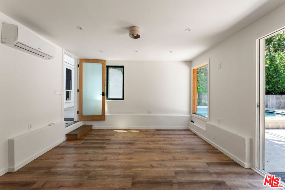 1530 Elevado Street Los Angeles, CA 90026 - Photo 35 of 44 an empty room with wooden floor and windows
