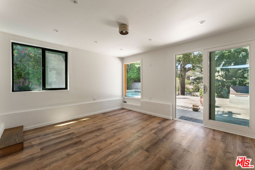 1530 Elevado Street Los Angeles, CA 90026 - Photo 36 of 44 a view of an empty room with wooden floor and a window