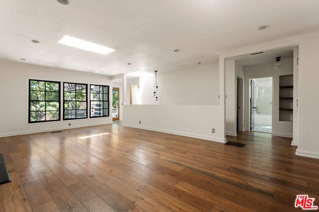 1530 Elevado Street Los Angeles, CA 90026 - Photo 38 of 44 a view of an empty room with wooden floor and a window