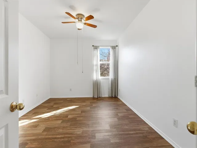 a view of a livingroom with a hardwood floor and a ceiling fan