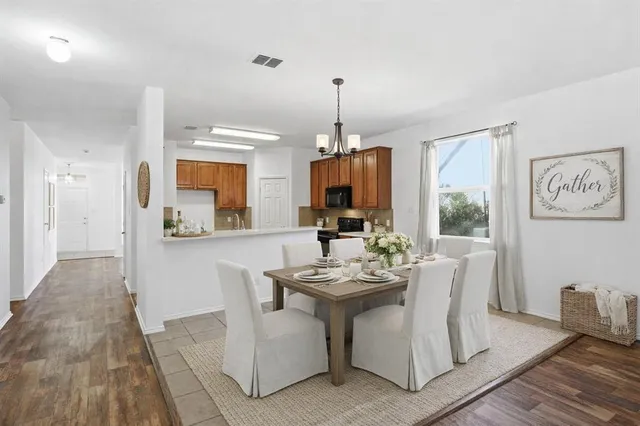 a view of a dining room with furniture window and wooden floor