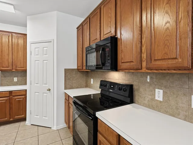 a kitchen with stainless steel appliances a stove a microwave and cabinets