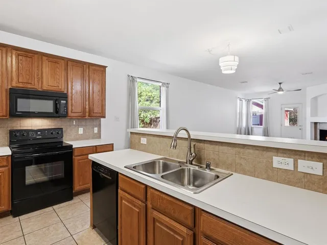 a kitchen with a sink and a stove top oven