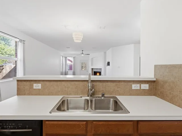 a kitchen with a sink cabinets and window