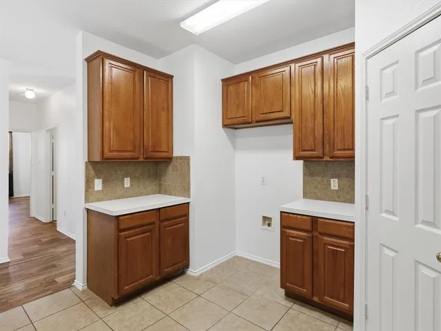 a kitchen with stainless steel appliances granite countertop wooden cabinets a sink and dishwasher
