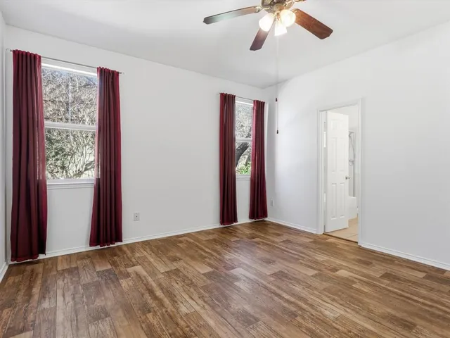 a view of a livingroom with a ceiling fan and window