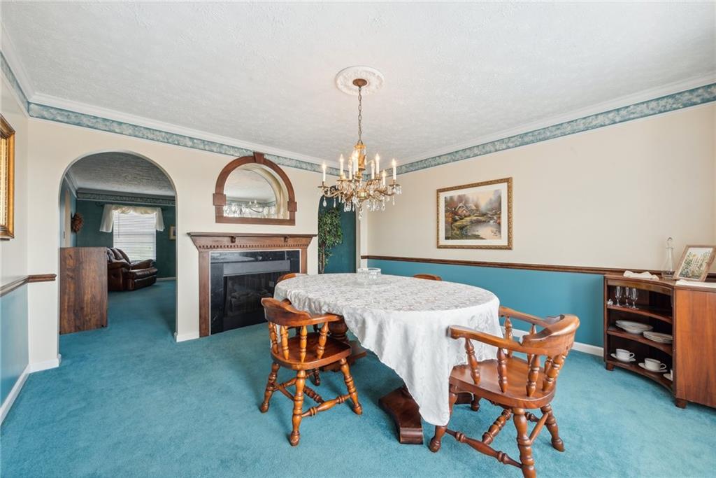 320 Talon Drive Irwin, PA 15642 - Photo 14 of 37 a dining room with furniture a rug and a chandelier