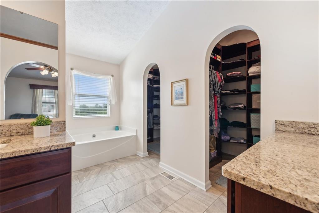 320 Talon Drive Irwin, PA 15642 - Photo 19 of 37 a bathroom with a granite countertop sink a vanity and a bathtub