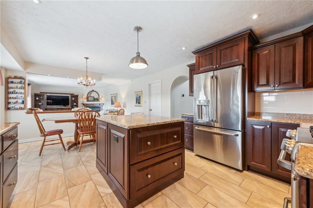 320 Talon Drive Irwin, PA 15642 - Photo 4 of 37 a kitchen with stainless steel appliances granite countertop a refrigerator and a stove top oven
