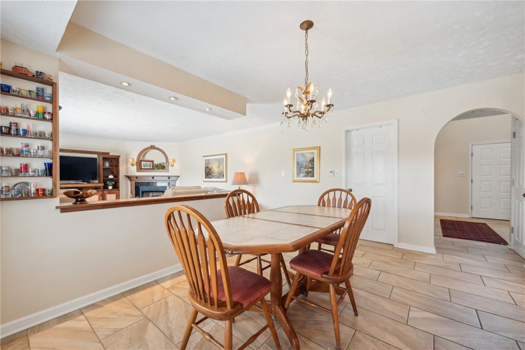 320 Talon Drive Irwin, PA 15642 - Photo 7 of 37 a dining room with furniture a chandelier and window