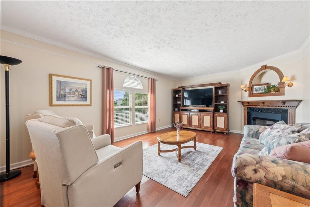 320 Talon Drive Irwin, PA 15642 - Photo 8 of 37 a living room with furniture a flat screen tv and a fireplace