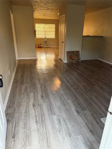 a view of a room with wooden floor