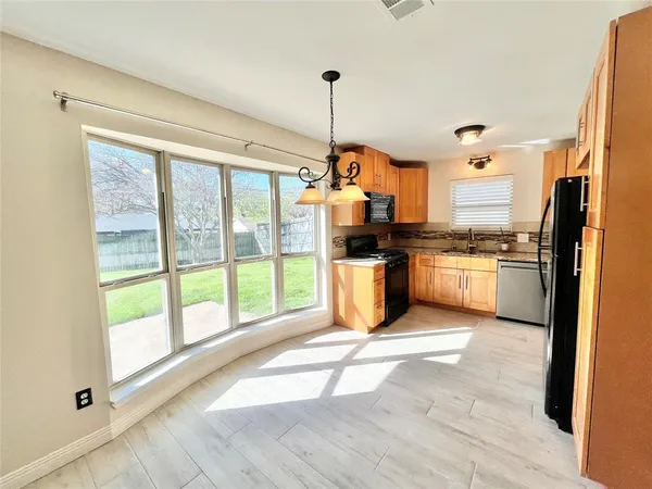 a kitchen with stainless steel appliances granite countertop a stove top oven and sink