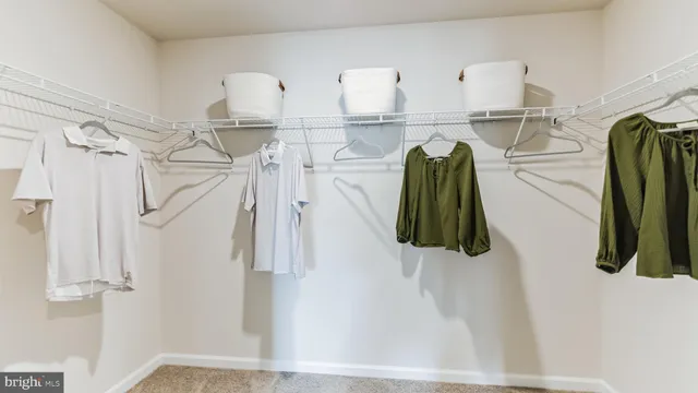 a bedroom with a bed and a dresser next to a window