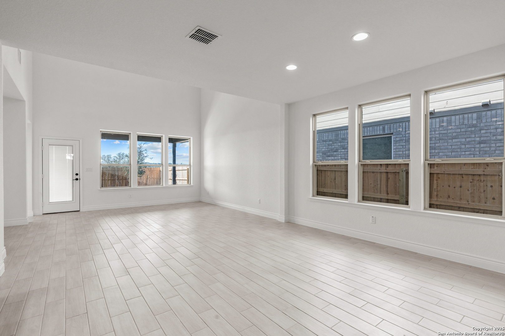 4044 Paddock Trail Seguin, TX 78155 - Photo 12 of 37 a view of an empty room with wooden floor and a window